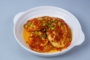 Balado spiced eggs or telur mata sapi pedas in a white plate. with copy space. Perfect for recipes, articles or any cooking content.