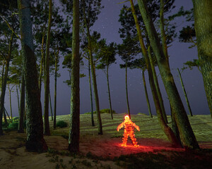 Light Painting of Human Figure in Forest at Night
