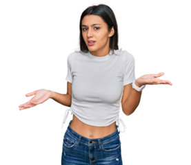Young hispanic girl wearing casual white t shirt clueless and confused with open arms, no idea concept.