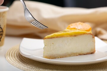 Delicious orange cheesecake with cream on plate