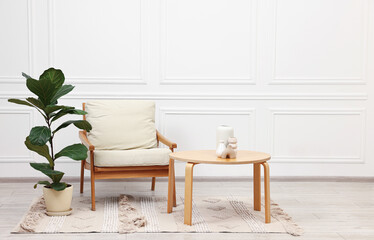 Beautiful interior with comfortable armchair and coffee table