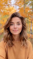 Fototapeta premium Young Woman in Autumn Forest Wearing Sweater with Colorful Foliage Background