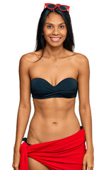 Fototapeta premium Young african american woman wearing bikini with a happy and cool smile on face. lucky person.