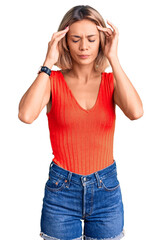 Beautiful caucasian woman wearing casual clothes with hand on head for pain in head because stress. suffering migraine.