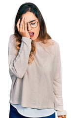 Beautiful hispanic woman wearing casual sweater and glasses yawning tired covering half face, eye and mouth with hand. face hurts in pain.