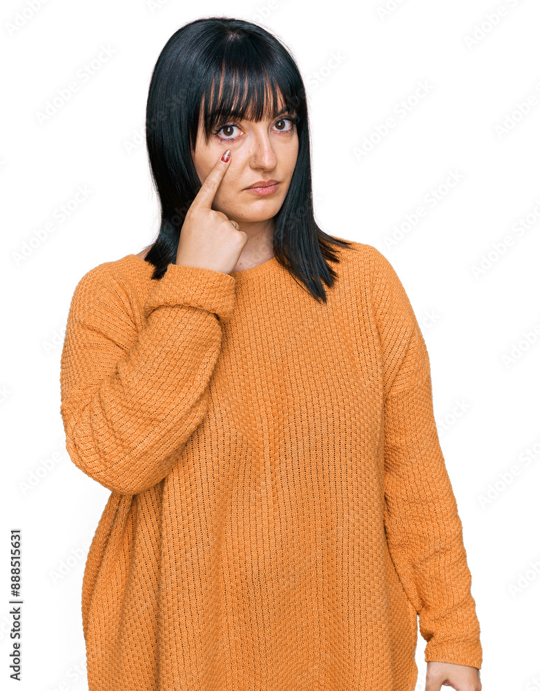 Sticker Young hispanic woman wearing casual clothes pointing to the eye watching you gesture, suspicious expression