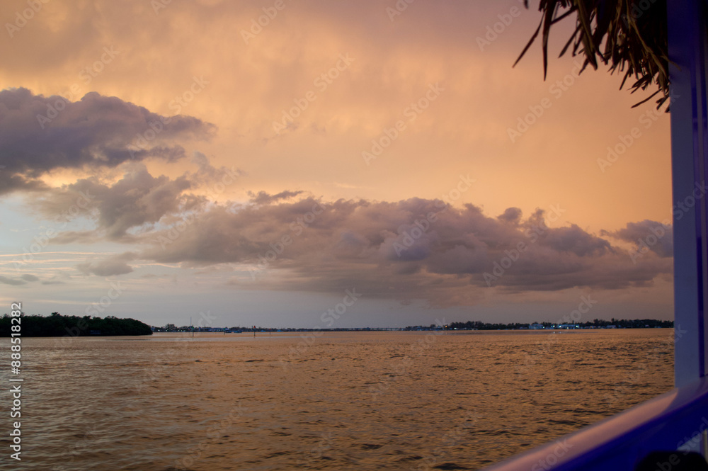 Wall mural sun setting over the gulf of mexico from the point of view of a viewer on a boat.