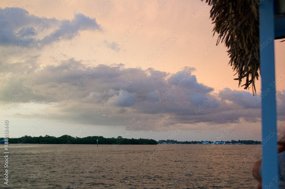 Wall mural sun setting over the gulf of mexico from the point of view of a viewer on a boat.
