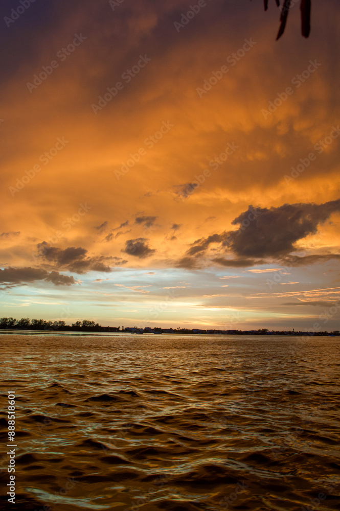 Wall mural sun setting over the gulf of mexico from the point of view of a viewer on a boat.