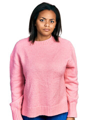 Beautiful hispanic woman wearing casual winter sweater skeptic and nervous, frowning upset because of problem. negative person.