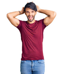 Handsome hispanic man wearing casual clothes posing funny and crazy with fingers on head as bunny ears, smiling cheerful