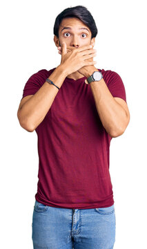 Handsome hispanic man wearing casual clothes shocked covering mouth with hands for mistake. secret concept.