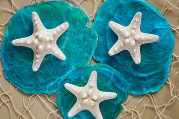 SEA photo wallpaper.Marine background.Marine texture in beige and blue tones. White dry starfish on...