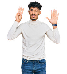 Young arab man wearing casual winter sweater showing and pointing up with fingers number eight while smiling confident and happy.