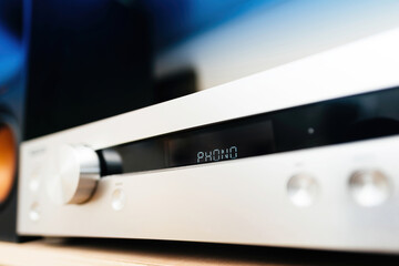 Phono turntable input on a preamplifier in an audiophile room, low-angle view of the aluminum panel...
