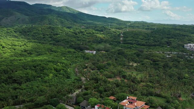 Scenic Aerial Backtrack: Tropical Jungle Landscape and Coastal Property Revealed