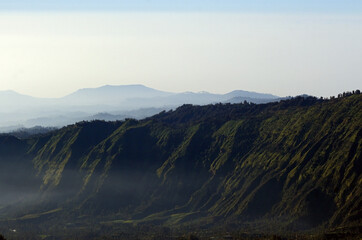 Misty valley at north-east of Mount Bromo in East Java, Indonesia