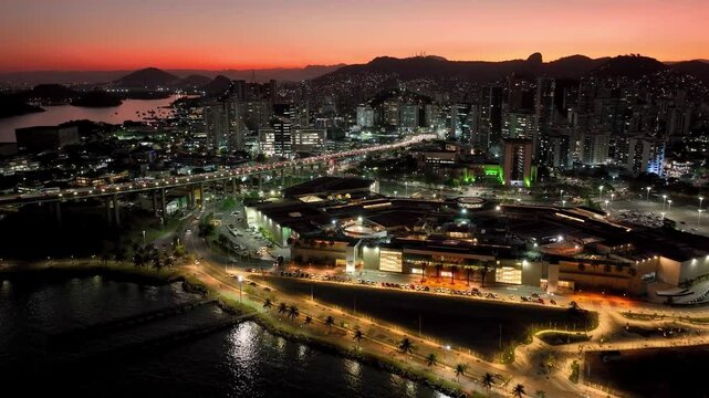 Sunset Vitoria Skyline At Vitoria Espirito Santo Brazil. Traffic Is Moving Across A Modern Cable-Stayed Bridge. Building Construction Landscape High Rise Building Vibrant.