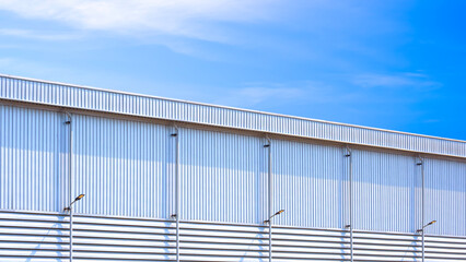 Large industrial warehouse building with rain gutter and rainwater drainage pipelines with LED...