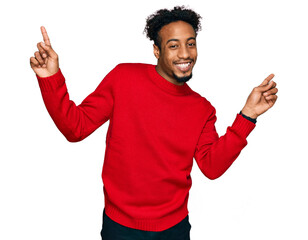Fototapeta premium Young african american man with beard wearing casual winter sweater smiling confident pointing with fingers to different directions. copy space for advertisement