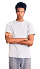 Young african american man wearing casual clothes skeptic and nervous, disapproving expression on face with crossed arms. negative person.