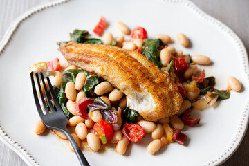 PAN-FRIED TILAPIA WITH CANNELLINI BEANS AND SWISS CHARD