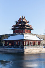 Fototapeta premium winter sonw view of the corner tower and moat of the Forbidden city