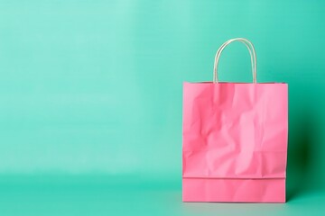 Pink paper bag on a pastel green background, ideal for minimalistic mockup designs with ample copy space, flat style.