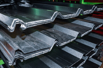 Neatly stacked corrugated galvanized steel sheets, ideal for roofing and wall construction. Durable, weather-resistant, and cost-effective, stored in a warehouse for shipping or installation