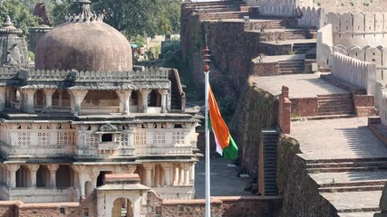 indian tricolor waving at ancient fort from flat angle video is taken at Kumbhal fort kumbhalgarh rajasthan india.