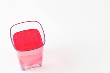 red drink on transparent glass