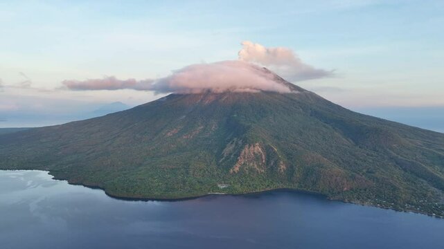 A serene dawn illuminates the scenic volcano of Lewotolok on island of Lembata, Indonesia. This beautiful and biodiverse area is part of the famed Ring of Fire and is volcanically active.