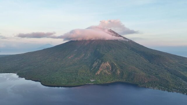 A serene dawn illuminates the scenic volcano of Lewotolok on island of Lembata, Indonesia. This beautiful and biodiverse area is part of the famed Ring of Fire and is volcanically active.