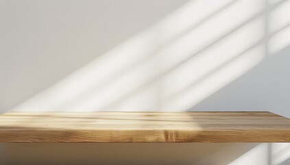 Empty Wooden Table Top with Sun Rays and Shadow Patterns on White Wall