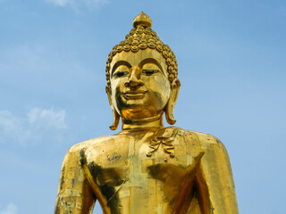 Big golden Buddha statue on a bright sky background - Landmark Famous sculpture statue in Thailand Temple.