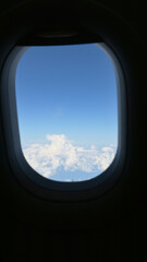 Scenery outside the window of a passenger plane, beautiful blue sky and white cloud view