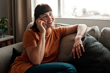 Fototapeta premium Woman, phone call and hello on sofa for chat, mobile app and talking in morning or living room. Networking, technology and person in home for discussion, social media and gossip for news or story