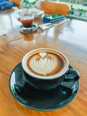 Cup of Caffé Latte on wooden table
