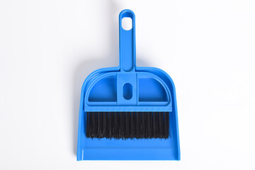 Small blue broom and dustpan set isolated on white background