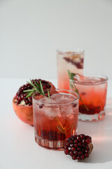 Red cocktail with fresh pomegranate on a white background