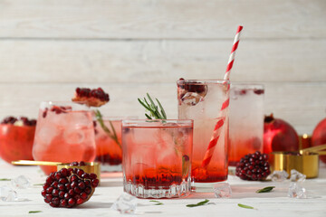 Red cocktail with fresh pomegranate on a white background