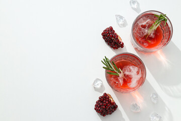 Cocktail with fresh pomegranate on a white background