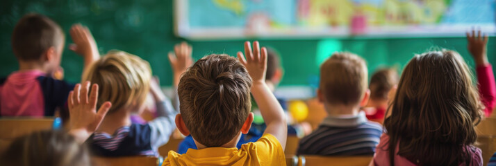 International Day of the Social Pedagogue. World Teacher's Day. the children are sitting in the classroom. Children raise their hand