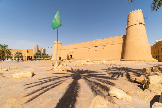 Riyadh, Saudi Arabia: Saudi national flag flies above the famous Masmak fort in Riyadh old town in Saudi Arabia capital city on a sunny day.