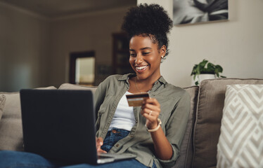 Woman, laptop and relax with credit card on sofa for online shopping for home decor, browsing and...