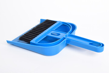 Small blue broom and dustpan set isolated on white background