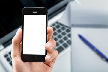 Modern smartphone with a blank screen at work desk