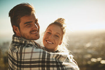 Portrait, happy and couple with blanket on mountain for hiking adventure, bonding and wake up from trekking journey. Smile, man and woman with love, relax and peace for hug on romance date outdoor