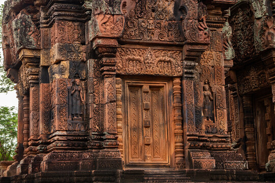 Carved bas relief in red sandstone of ancient devatas at Banteay Srei -citadel of women and beauty- Hindu Temple dedicated to god&nbsp;Shiva&nbsp;and&nbsp;Parvati, Siem Reap, Cambodia.