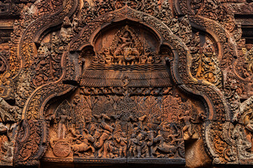 Pediment containing bas relief carved in red sandstone of ancient figures of animals at Banteay Srei -citadel of women and beauty- Hindu temple dedicated to god Shiva and Parvati, Siem Reap, Cambodia